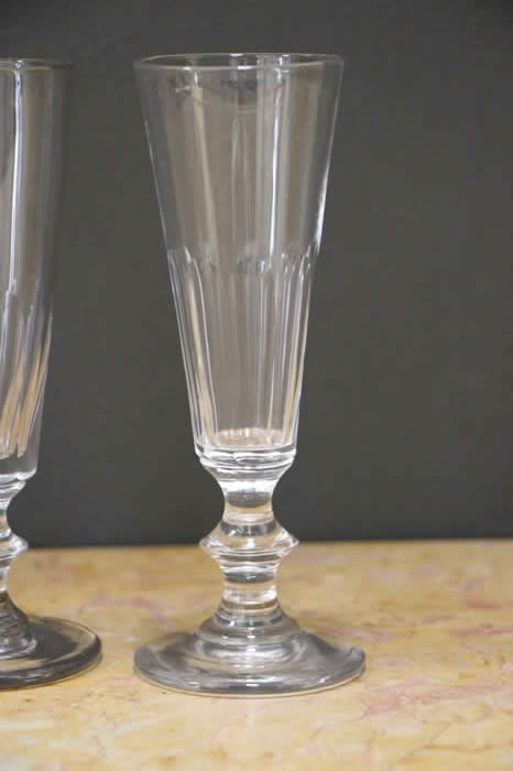 A Regency-style cut-glass ships decanter and four wine glasses